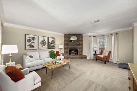 Inviting living room with fireplace, accent chairs, and plenty of space to gather