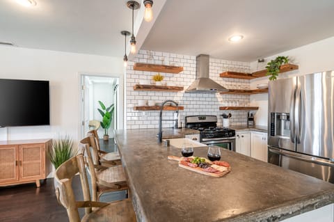 Full kitchen features a bar seating, coffee maker, basic cooking essentials