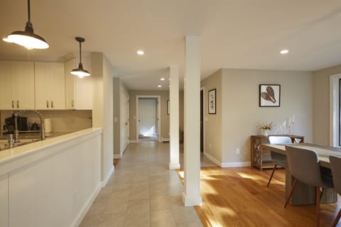 Beautiful spaces connect the living room, dining room area and mudroom.