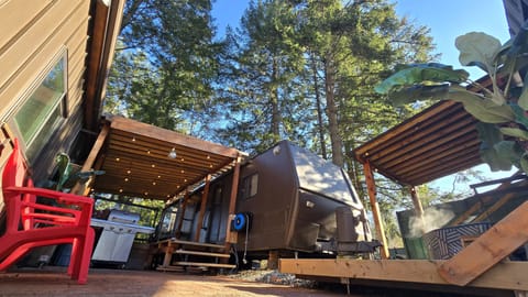 Outside hot tub under awning on the right.