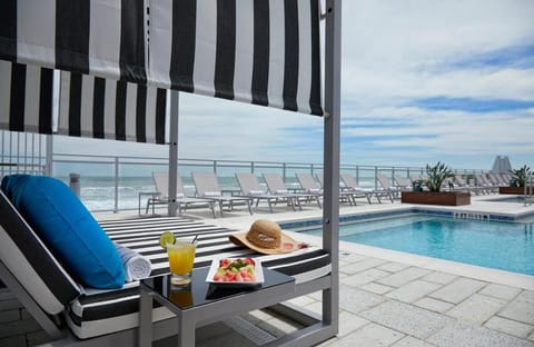 Lounge poolside with refreshing bites and ocean breezes.