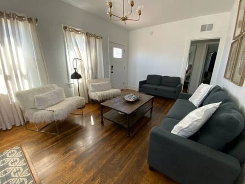 Quaint living room with gas fireplace, smart TV, and plenty of comfortable seating
