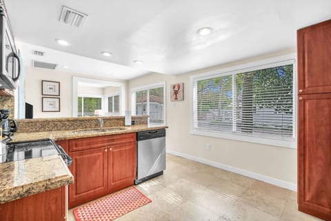 Neat, expansive, and thoughtfully equipped kitchen with ample storage, designed to fulfill your cooking necessities.