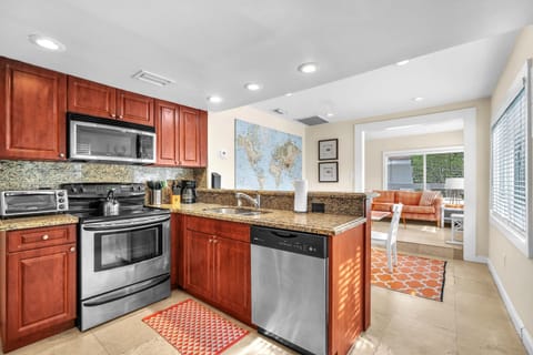 Neat, expansive, and thoughtfully equipped kitchen with ample storage, designed to fulfill your cooking necessities.
