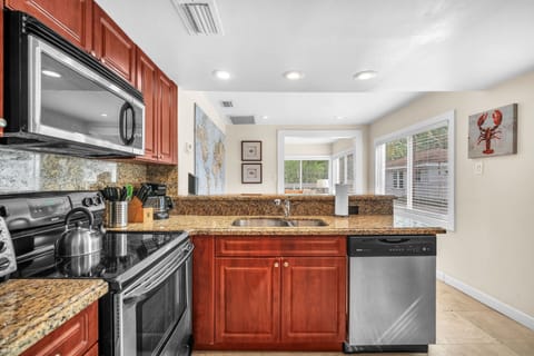 Neat, expansive, and thoughtfully equipped kitchen with ample storage, designed to fulfill your cooking necessities.