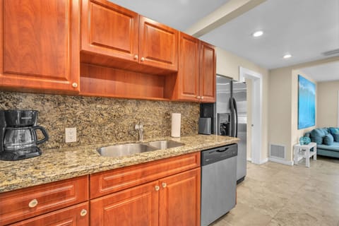 Spotless, generously-sized, and equipped kitchen with ample storage, ensuring a seamless cooking experience.