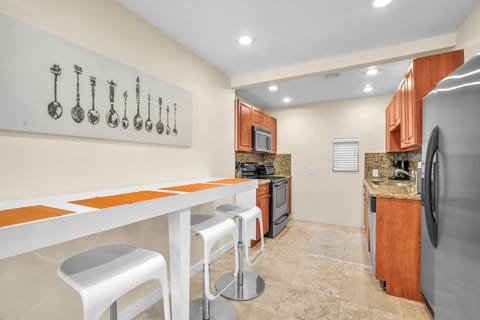 Spotless, generously-sized, and equipped kitchen with ample storage, ensuring a seamless cooking experience.