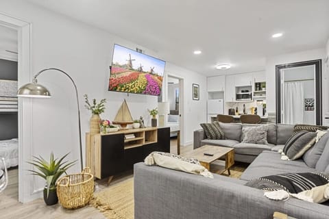 Sofa, coffee table, fast wi-fi,Smart TV, Modern Art, and Central Air Conditioning in the Living Room.