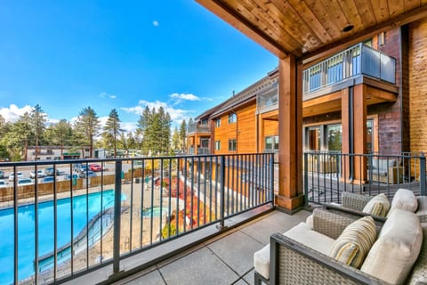 Relax on your private balcony with plush seating overlooking the sparkling pool and mountain pines.