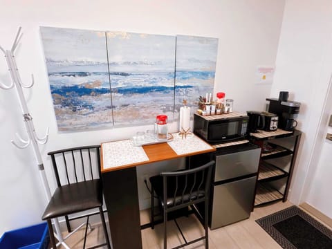 Living room, with fridge, microwave, coffee maker, dining/study table