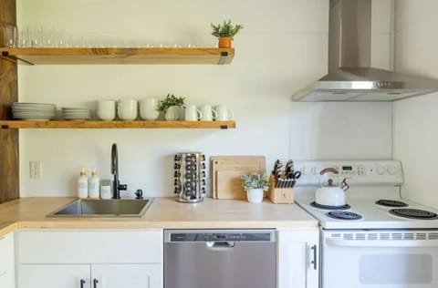 Our kitchen with wine & drinking glasses, coffee mugs and a full set of dishware