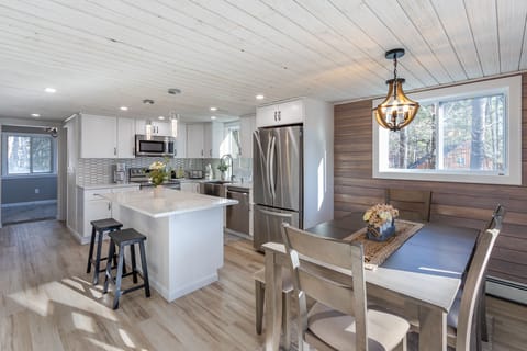 Kitchen and dining area with a view down the hall to the entry way