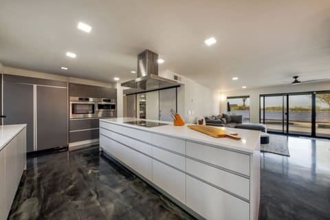 Sleek, fully-equipped chef`s kitchen with top-of-the-line appliances