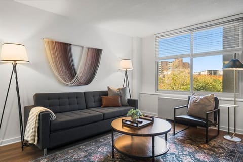 Step into this living room, where comfort meets style. The soft pillows and luxurious blanket are perfect for you to snuggle into while watching a movie or enjoying a quiet evening.