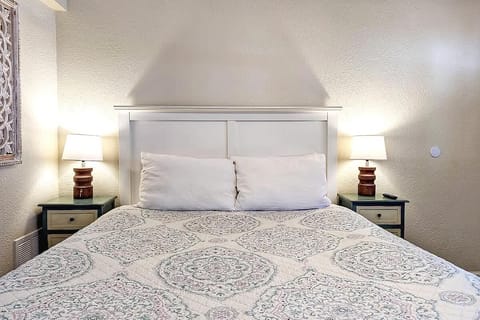  A calm bedroom first impression with soft lighting, layered bedding, and a composed, restful feel.
