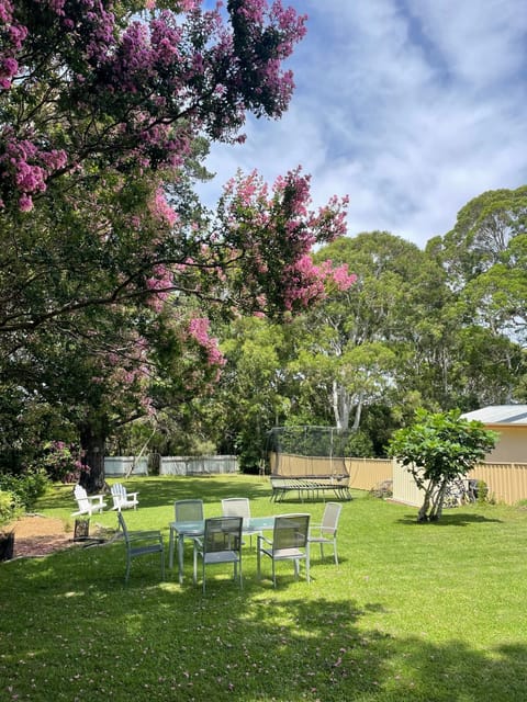 Huge backyard with firepit, outdoor dining, trampoline and tree swing.