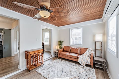 Need a quiet escape? This secondary living room features soft seating, a ceiling fan, and a peaceful atmosphere—perfect for curling up with a book!