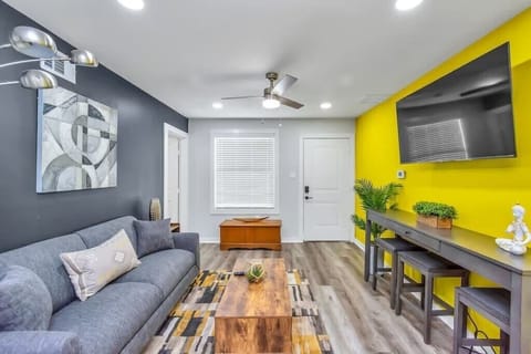 Sofa, coffee table, fast wi-fi,Smart TV, Modern Art, and Central Air Conditioning in the Living Room.
