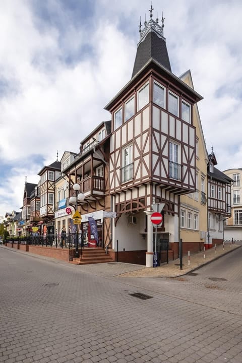 A half-timbered historic building on a European street with a classic design.

