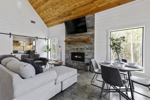 Savor your meals by the cozy fireplace while gazing out at the majestic pine trees surrounding you.