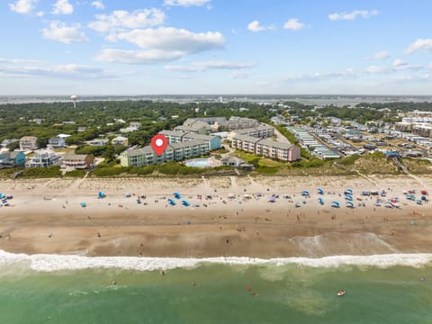 Aerial view of beachfront property with direct beach access and convenient location near coastal amenities.