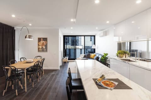 Experience the harmonious flow of the open-plan living space connecting the kitchen, living area, and dining area.