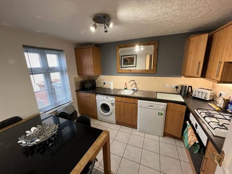 Fully equipped kitchen with dining/work area.