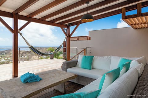 Nice outdoor living room with sofas under the covered terrace. 