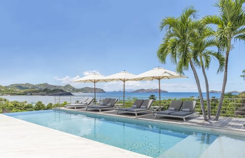 Large heated pool on the main level, smaller heated pool on the lower level, ideal for kids. Large teak terrace, with deckchairs. Outdoor dining and lounge areas. Gas barbecue. 