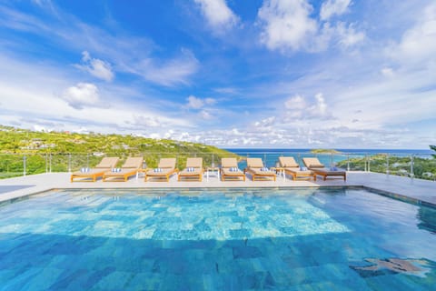 One large heated  pool on the main level. Second pool on the lower level, next to bedroom 5. Deckchairs . Magnificent view on the bay of Marigot. 