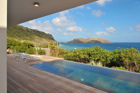 Heated pool 3.5 x 11 m  on the lower level, deck chairs and outdoor lounge area. 