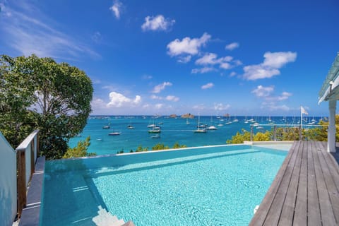 Beautiful terrace around the pool, deckchairs, and sund beds. 