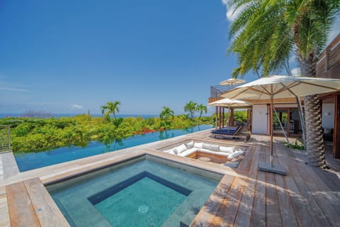 Large deck terrace around the heated swimming pool with stairs, jacuzzi, several sun beds with parasol, gas barbecue, outdoor sound system. 