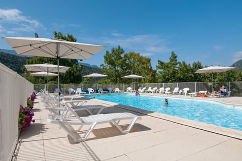 Relax by the pool with stunning mountain views. Enjoy ample lounge chairs and umbrellas for a perfect sunny day