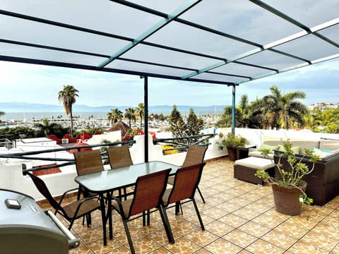 Rooftop deck with gas grill (propane included!), dining table and couch. There is an overhead canopy for shade during the day and cafe lights at night!