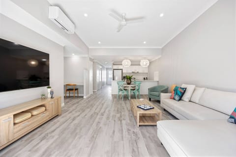 The open-plan living and dining area is air-conditioned and spacious. Relax and watch your favourite shows from the L-shaped sofa.  