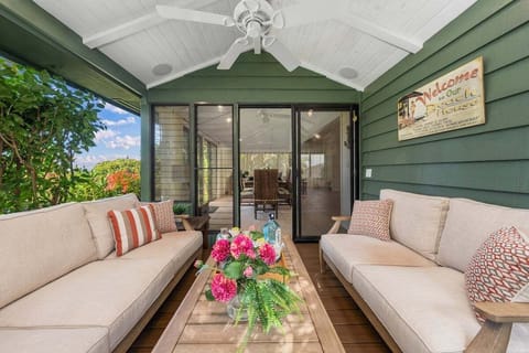 Relax in this inviting outdoor lounge with plush seating and tropical views