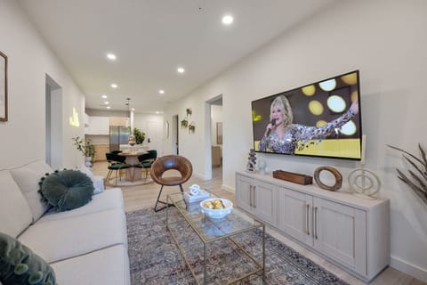 Open-concept floor plan seamlessly flowing the living room, dining area and fully equipped kitchen into one large space to keep your group together.