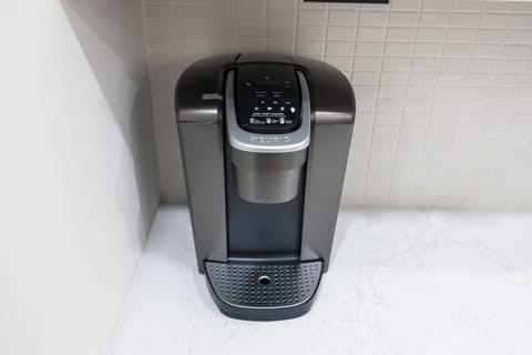 Fully equipped kitchen boasting brand-new stainless-steel appliances and a large island with bar seating stocked with all culinary essentials for ease and convenience during your stay.