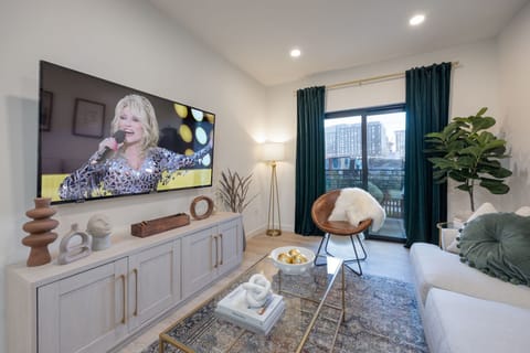 Bright and modern living room featuring a Smart TV, and comfortable living room furnishings to unwind after a long day accompanied by a private balcony.