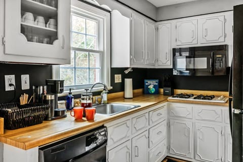 Kitchen with ample cupboards coffee station and glass and dish wares