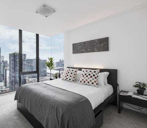 Rest easy in the primary bedroom featuring a queen bed and stunning city views.