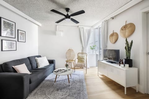 Lounge around in the spacious living area complete with a cosy sofa, rattan reading chair and a flat-screen TV. A ceiling fan keeps things comfortable. 