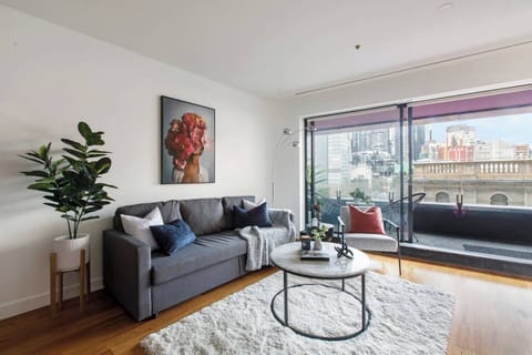 The open-plan living area is thoughtfully styled with warm decor and a TV to help you feel at home.