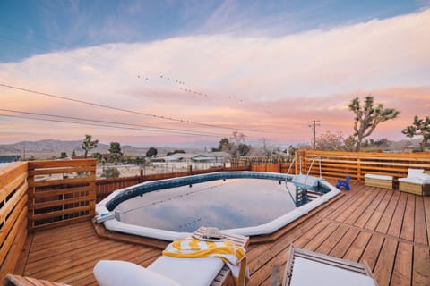 Sunset over the pool with mountain views and joshua trees