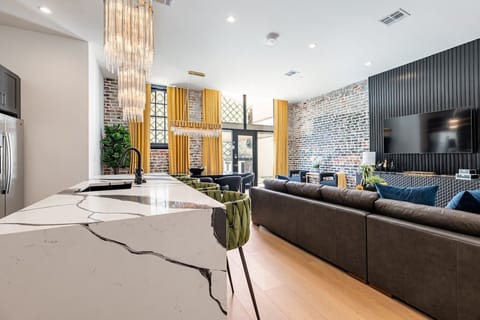 Living Room opens up to pool. Features queen-size sleeper sofa.