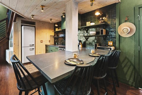 The kitchen features a Smeg fridge, gas stove, microwave, pots & pans, and the dishes and utensils you need.