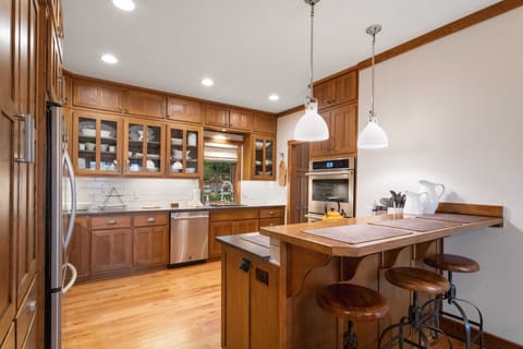Spacious Kitchen with Bar Seating, Granite Countertops, and Stainless Steel Appliances
