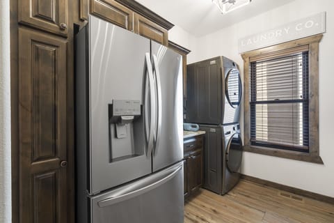 Main floor laundry and additional full sized fridge just off of the kitchen