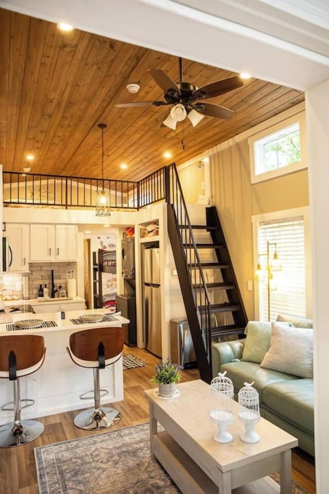 Living room with bar top and loft access.